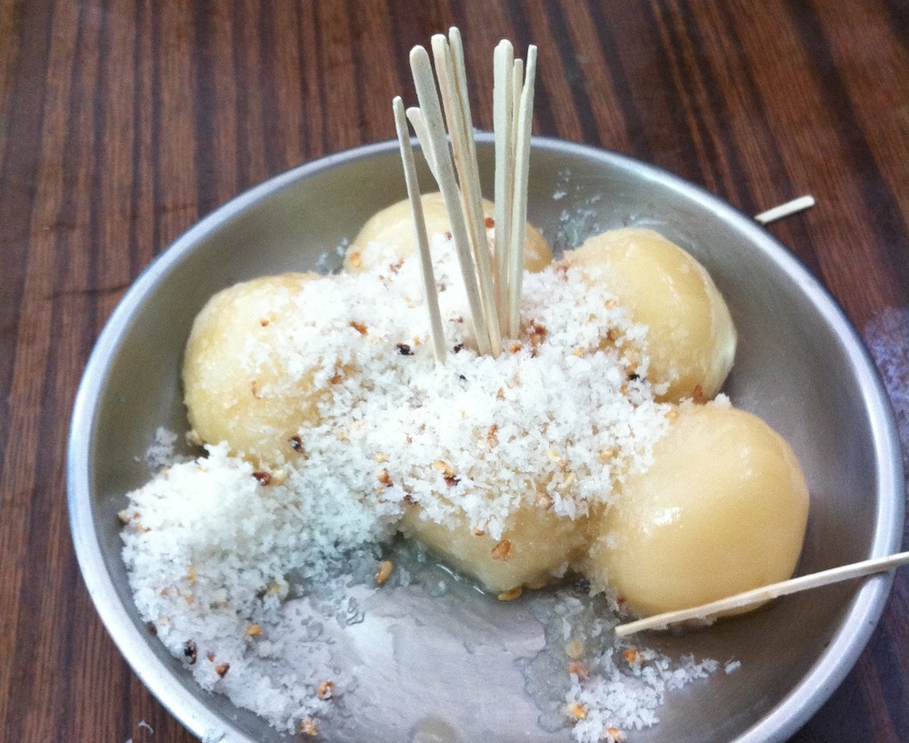 Sticky rice balls topped with sugar and coconut