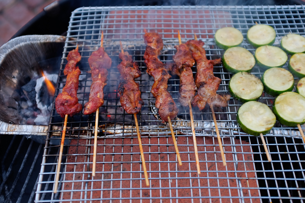 Meat and zucchini cooking on the makeshift shao kao grill