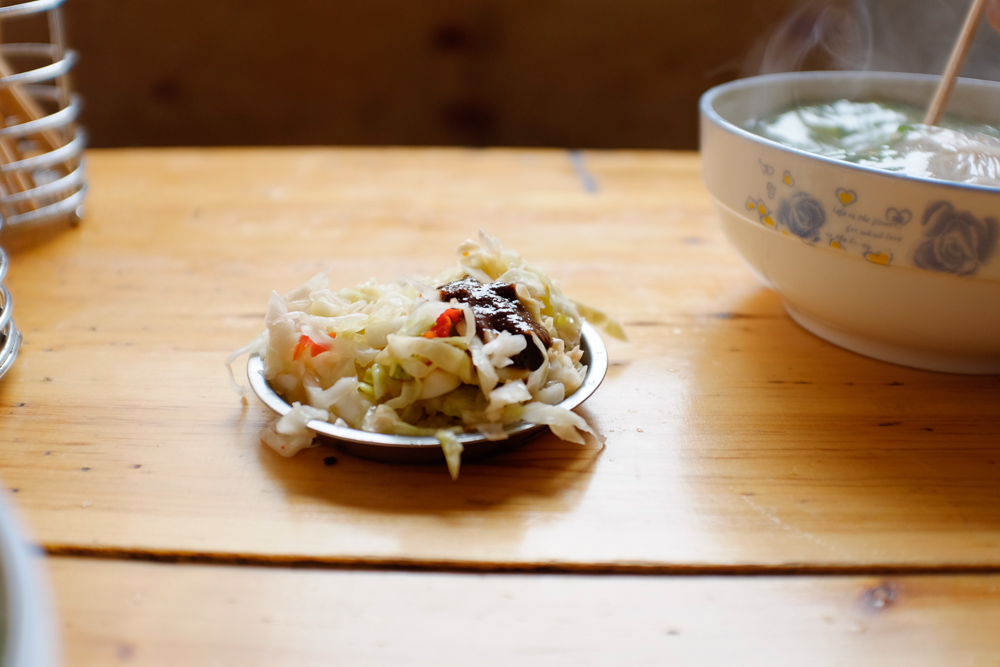 Cabbage pickle and a dollop of ridiculously spicy dried chile paste to add to the noddles in Yuanyang