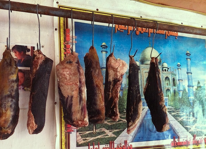 Cuts of beef aging in the dining room of Shaxi's Long Feng Muslim Restaurant