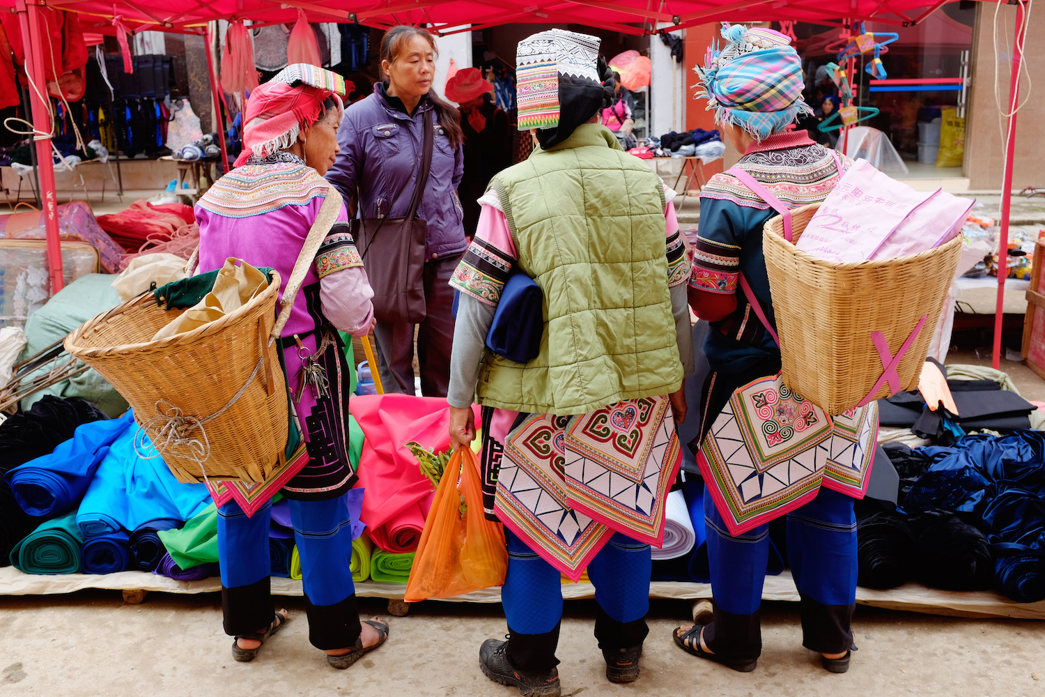 Yi  minority women shopping for cloth