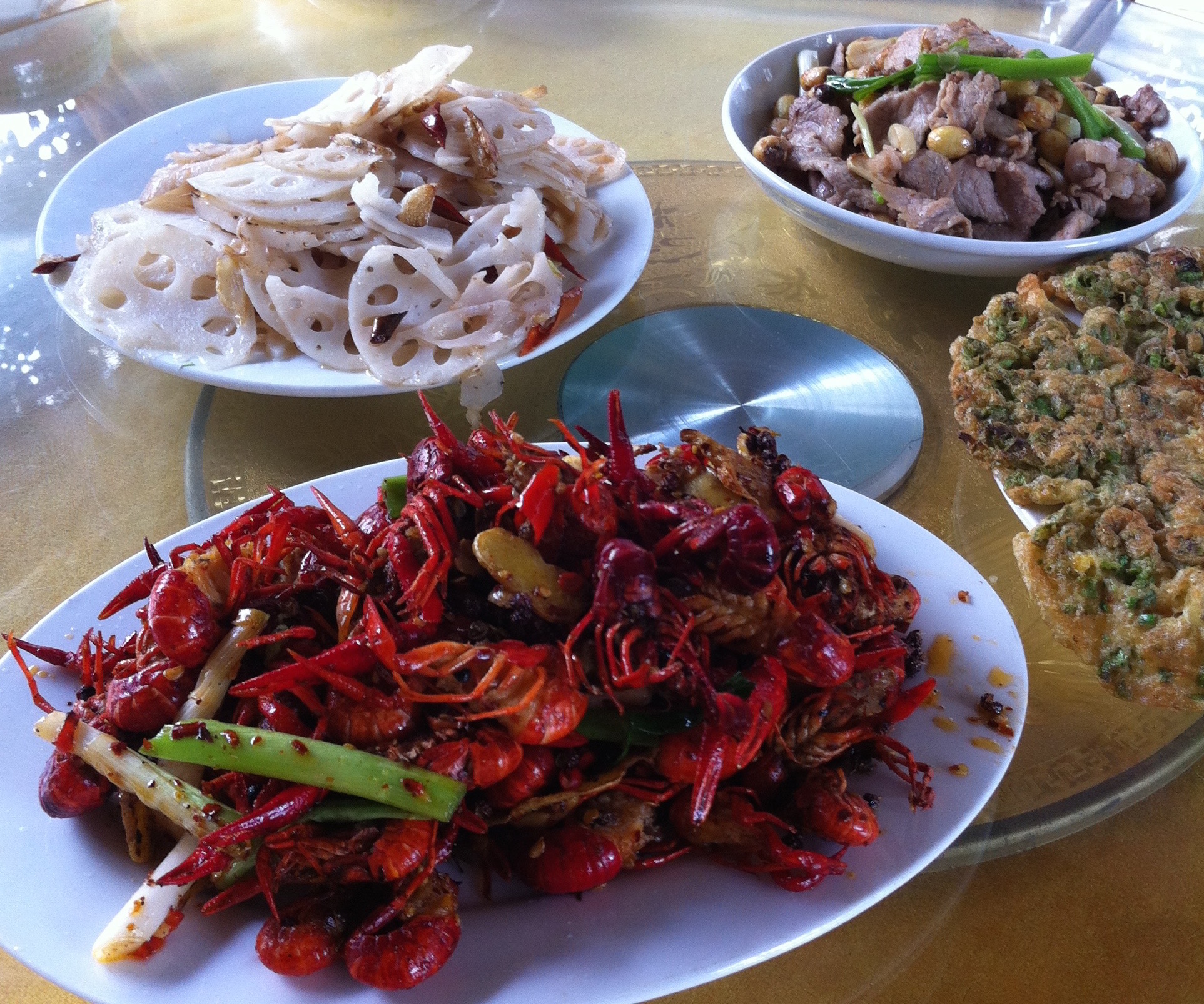 Lunch pulled from the lake: crawfish, lotus root, pork with lotus seeds, and eggs with lotus leaf.